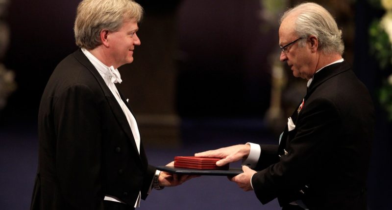 FILE - The 2011 Nobel Prize Laureate for Physics Dr Brian P. Schmidt from Australia receives his Nobel Prize from Sweden