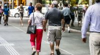 Two old people walk down the street in Brisbane