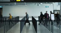 MELBOURNE, AUSTRALIA - NOVEMBER 23: People are seen at Melbourne Airport checking in for flights to New South Wales on November 23, 2020 in Melbourne, Australia. COVID-19 restrictions have relaxed further in Victoria as the state continues to record no new coronavirus cases. From Monday, Victorians no longer need to wear masks when outside at all times, with people only required to wear masks when indoors and on public transport, or in places outside where social distancing is not possible. Unde