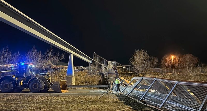 This image provided by the Alaska Department of Transportation & Public Facilities shows fencing and the roof of a walkway after collapsing onto the Seward Highway in Anchorage, Alaska, on Sunday, Jan. 12, 2025. (Alaska Department of Transportation & Public Facilities via AP)