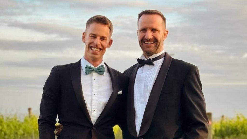 Footy star who made history when he came out as gay has surprise wedding - and a sporting legend flew him to the ceremony in a helicopter