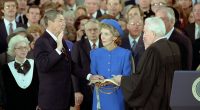 Nancy Reagan looks on as President Ronald Reagan is sworn in by Warren Burger beneath the Capitol Dome on Jan. 21, 1985.