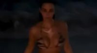 Kim Kardashian looks incredible as she strips off to tiger print bikini and goes for a dip in the ocean