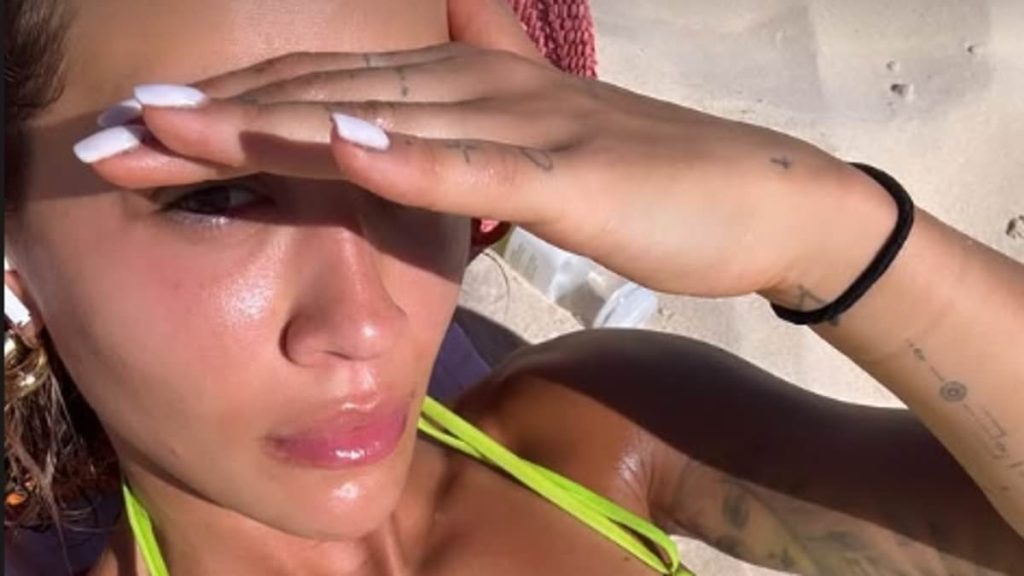 Rita Ora shows off her lithe physique in stylish neon green bikini after working up a sweat at the gym during New Zealand getaway