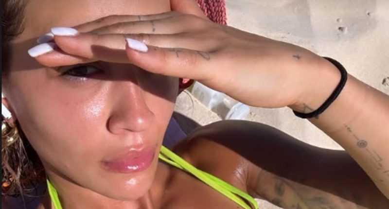 Rita Ora shows off her lithe physique in stylish neon green bikini after working up a sweat at the gym during New Zealand getaway