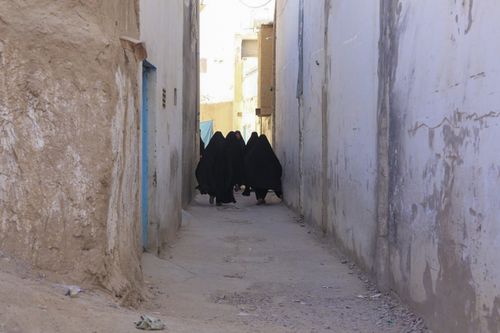 KANDAHAR, AFGHANISTAN - SEPTEMBER 29: Women walk at a street in Kandahar, Afghanistan on September 29, 2021. Hazaras are known as the largest Shiite group in the country as they are Persian-speaking ethnic group native to Iran. Hazaras have their own schools, madrasas and mosques. (Photo by Bilal Guler/Anadolu Agency via Getty Images)