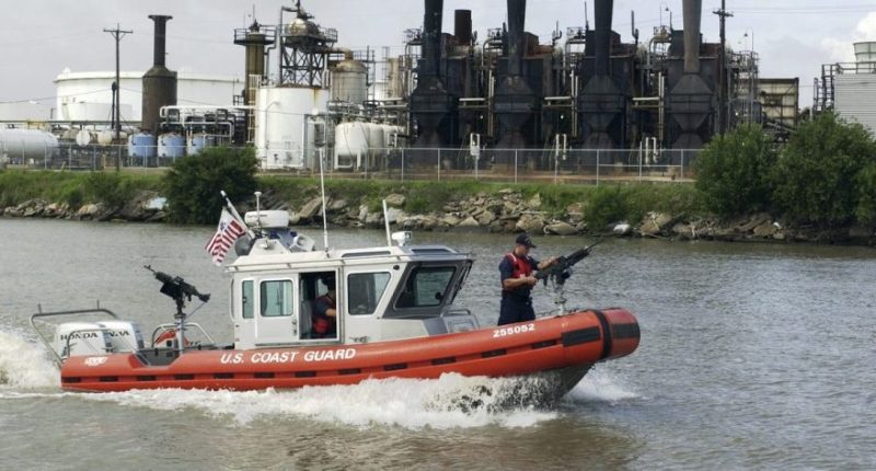In this 2004 file photo, a U.S. Coast Guard boat patrols past one of several refineries along the Houston Ship Channel in Houston. (AP Photo/Pat Sullivan, file)