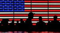 FILE - People stand in Times Square in New York, Aug. 9, 2024. (AP Photo/Pamela Smith, File)