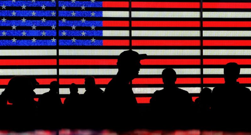 FILE - People stand in Times Square in New York, Aug. 9, 2024. (AP Photo/Pamela Smith, File)