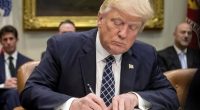 President Donald Trump signs an executive order in the Roosevelt Room of the White House in Washington, April 25, 2017. (AP Photo/Andrew Harnik, File)