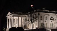 Why are US flags being flown at half-staff on Inauguration Day?