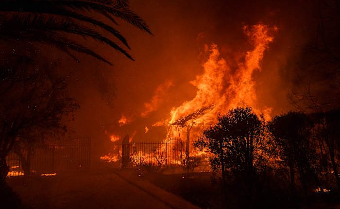 Wildfires latest: Winds subside as firefighters battle devastating blazes in Los Angeles area