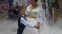 An eight-year-old boy dancing with his thirteen-year-old bride at their wedding in Russia.