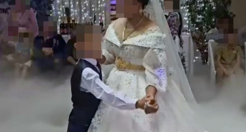 An eight-year-old boy dancing with his thirteen-year-old bride at their wedding in Russia.