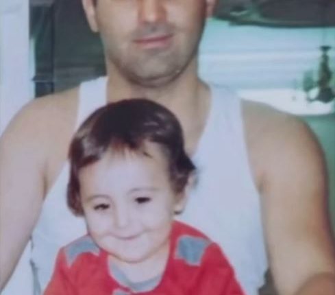 Photo of a man holding a toddler.