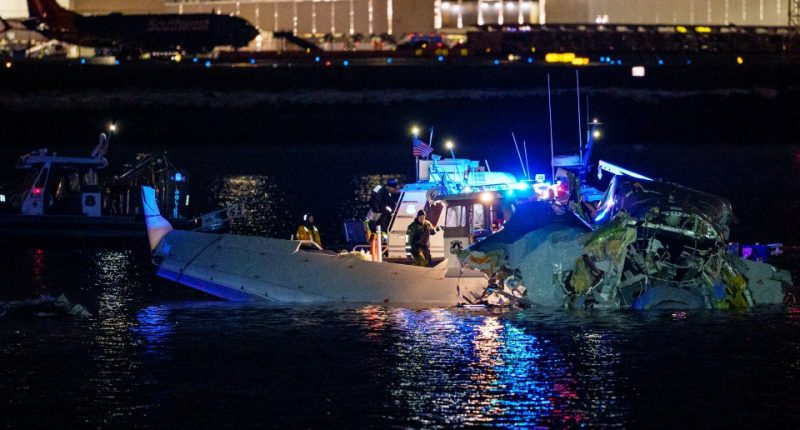 Airplane wreckage in the Potomac River with emergency responders.