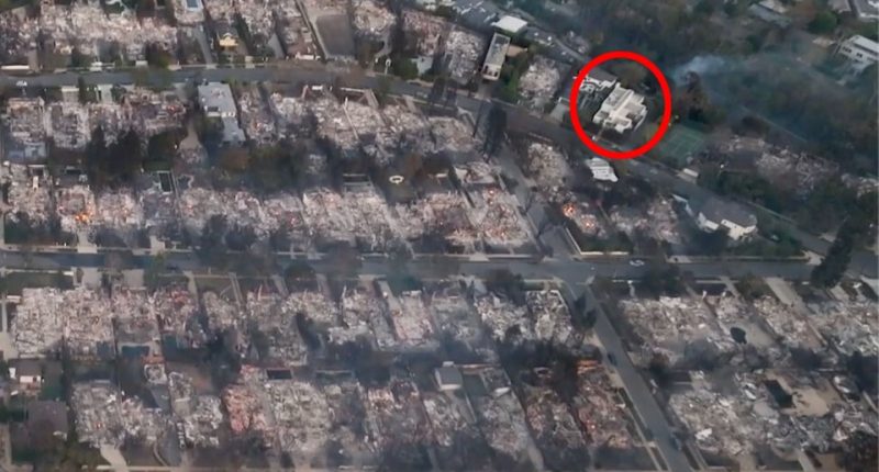 The white building on the top left has been dubbed LA's luckiest home after it became the last standing in its burned-down district