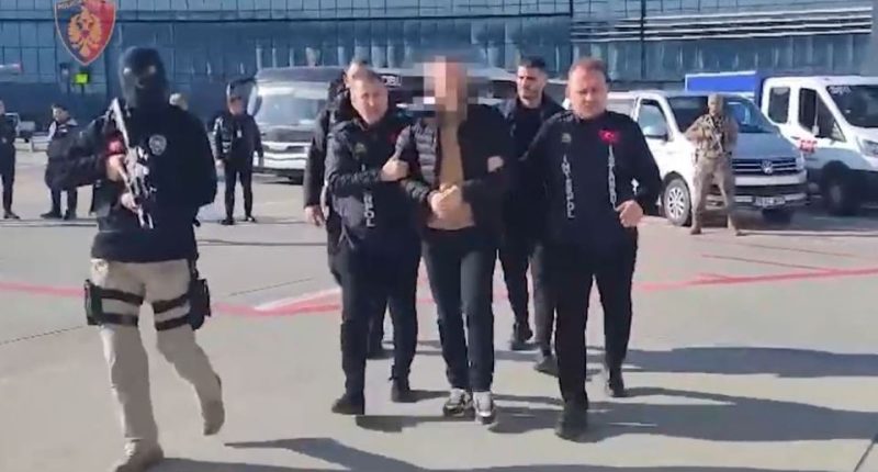 Police escorting a suspected drug trafficker at an airport.