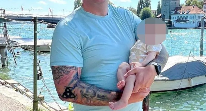 Dad Livelsberger holding up a young child earlier this year