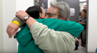 Two people embracing in a hallway.