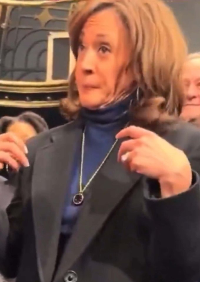 Kamala Harris adjusting her necklace.