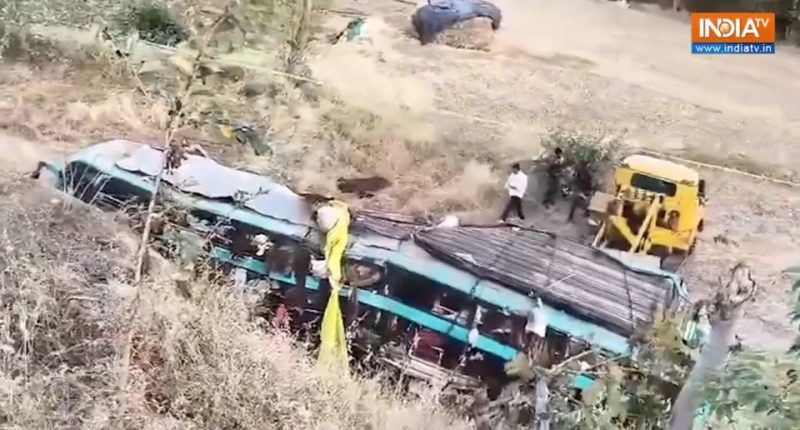 Bus crash scene with rescue workers.