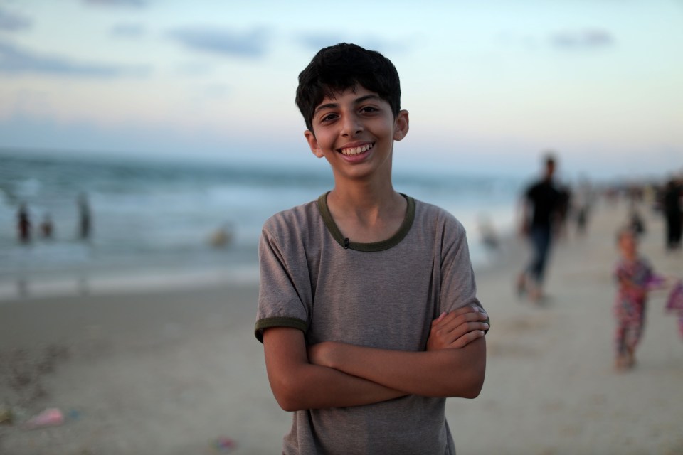 Smiling boy on a beach.