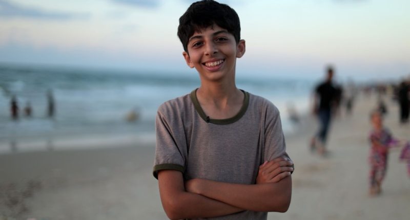 Smiling boy on a beach.