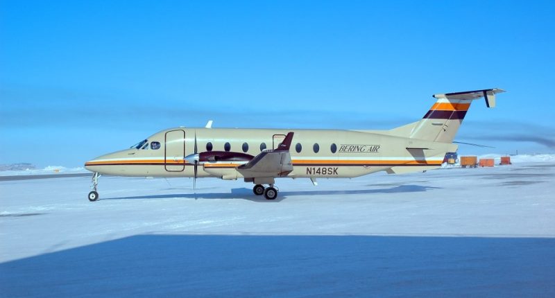 Beechcraft B1900D passenger airliner on a snowy airfield.