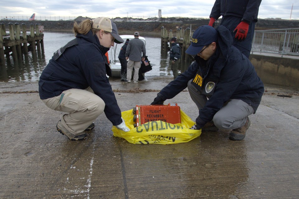 Salvage crew recovering wreckage from a midair collision in the Potomac River.