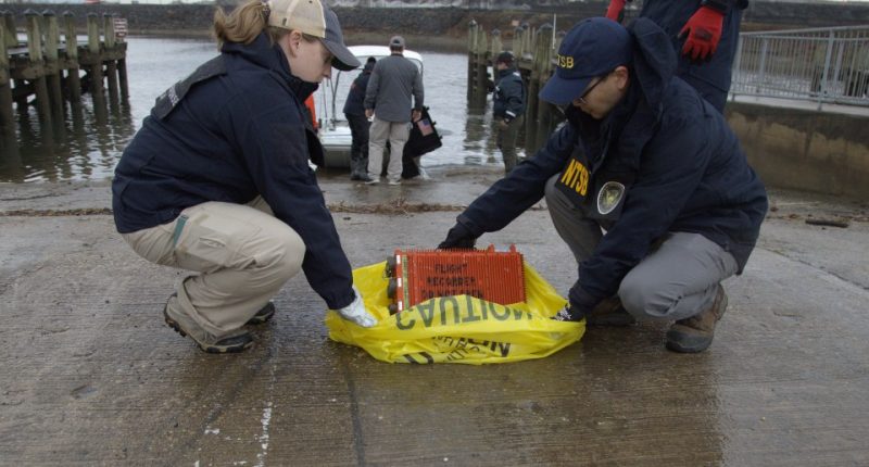Salvage crew recovering wreckage from a midair collision in the Potomac River.