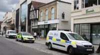 Police and ambulance vehicles outside a Fenwick department store.