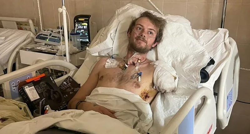 British humanitarian worker Edward Scott in a hospital bed, having lost an arm and leg.