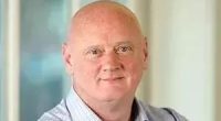 Headshot of a bald man.