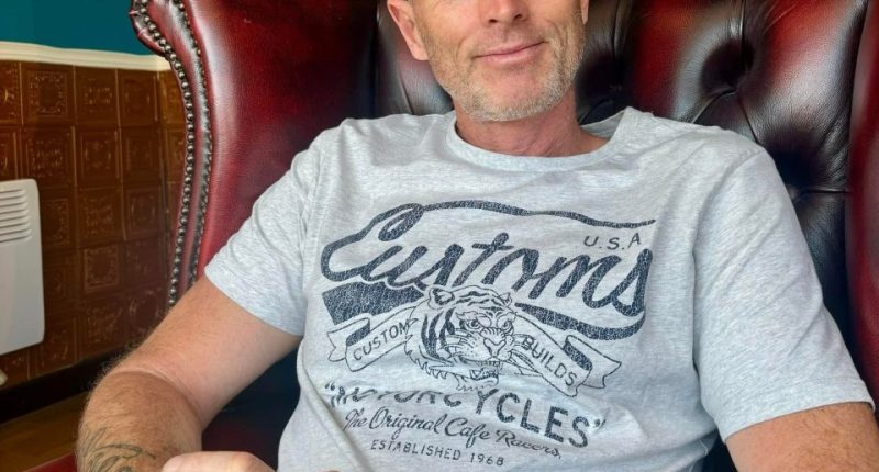 Craig Foreman, a British man detained in Iran, sits in a chair.