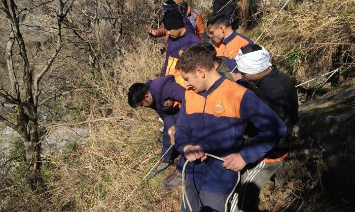Rescue team using ropes in a mountainous area.