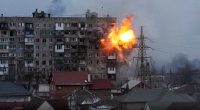 Explosion damaging an apartment building.