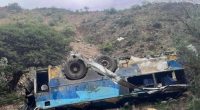 Wrecked bus on a hillside.