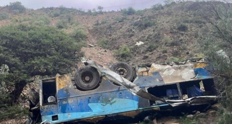Wrecked bus on a hillside.