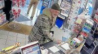 Surveillance image of a man making a purchase at a tobacconist.