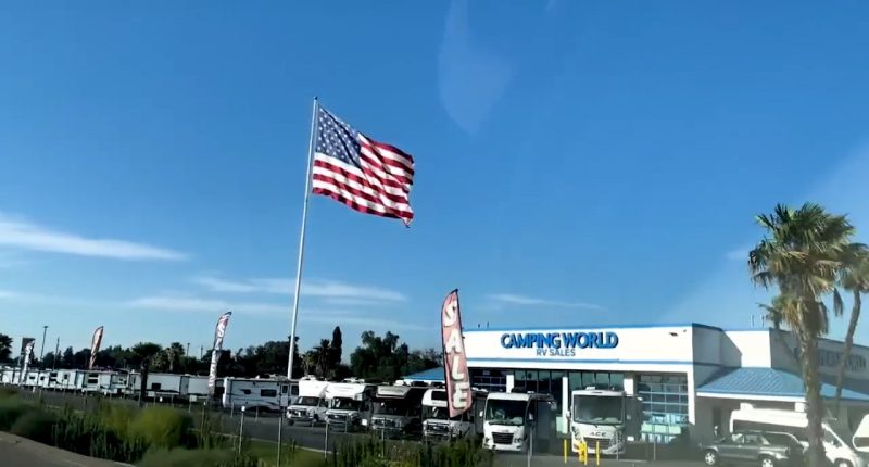 Camping World CEO defies another city's threat of legal action over huge American flag: Not 'coming down'