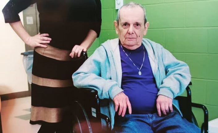 Photo of a woman and an elderly man in a wheelchair.