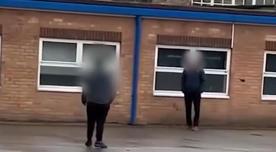 Police officers outside a school.