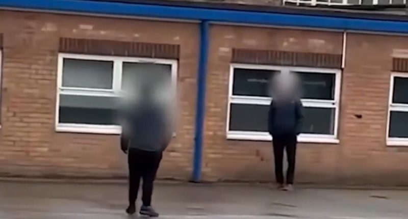 Police officers outside a school.