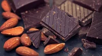 chocolate with almonds on black background