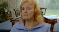 Woman in a blue jacket describes a timeshare issue.