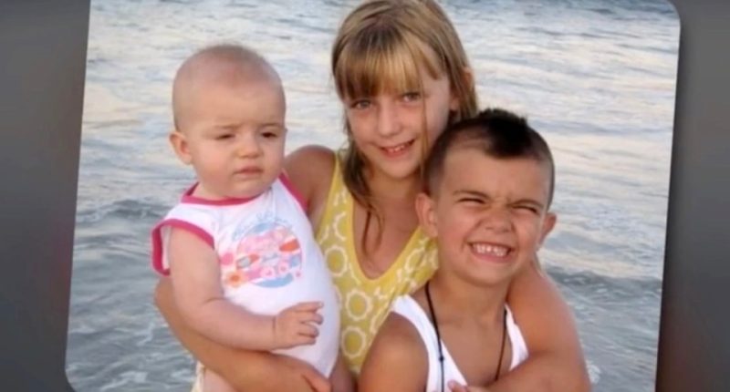 Three young children at the beach.