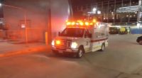 Ambulance at O'Hare International Airport after a plane hit a tug, critically injuring a worker.