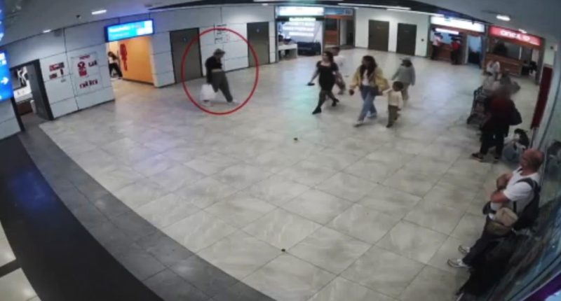 Security camera footage of a woman leaving a baby in a toilet at an airport.