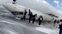 Passengers leaving a Delta Air Lines plane that crashed on landing.